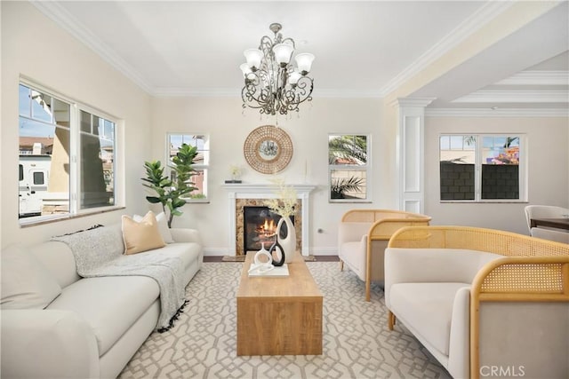 living area featuring baseboards, a fireplace, an inviting chandelier, and ornamental molding