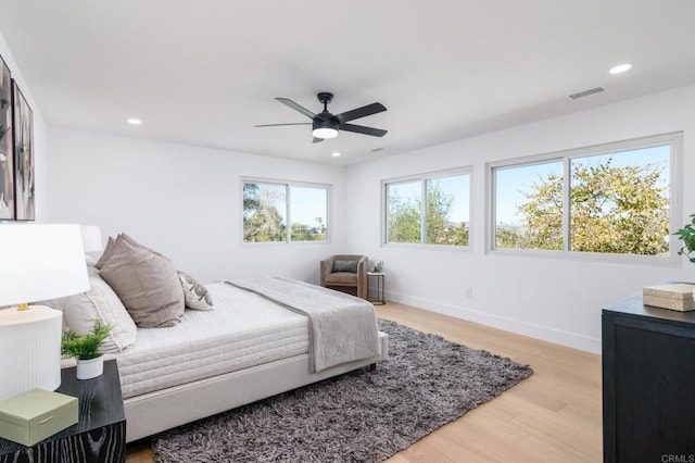 bedroom with recessed lighting, baseboards, light wood finished floors, and visible vents