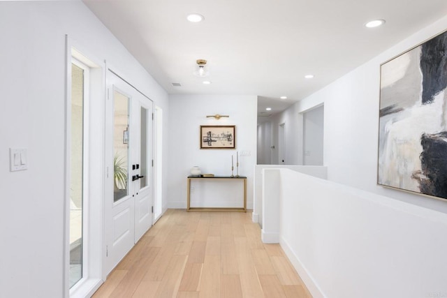 corridor with recessed lighting and light wood-style flooring