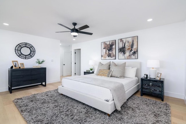 bedroom with light wood-style floors, recessed lighting, and baseboards