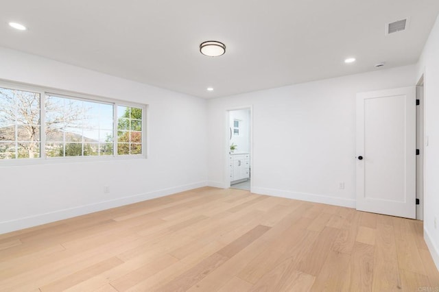 unfurnished room featuring recessed lighting, baseboards, visible vents, and light wood-style flooring