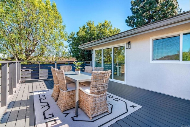 wooden terrace with outdoor dining space