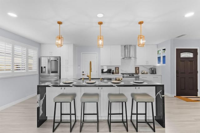 7162 Beagle St, San Diego, CA 92111 - kitchen featuring wall chimney exhaust hood, stainless steel appliances, a sink, a breakfast bar, and baseboards