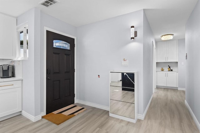 7162 Beagle St, San Diego, CA 92111 - foyer entrance with light wood-style floors and baseboards