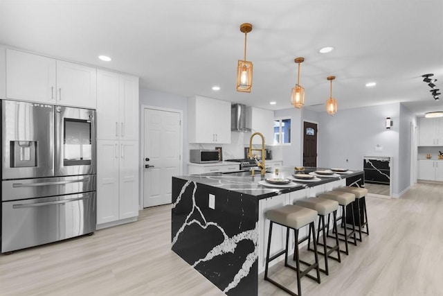 7162 Beagle St, San Diego, CA 92111 - kitchen featuring appliances with stainless steel finishes, wall chimney exhaust hood, light wood-type flooring, recessed lighting, and white cabinetry