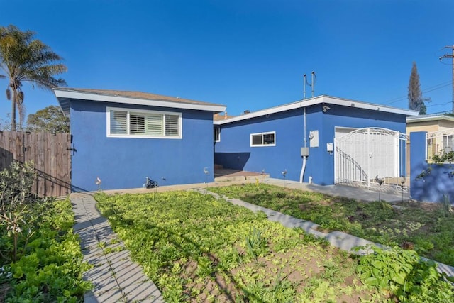 7162 Beagle St, San Diego, CA 92111 - view of front of home with stucco siding, a gate, an attached garage, and a patio