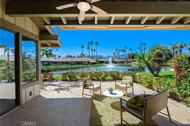 view of patio featuring a ceiling fan and a water view
