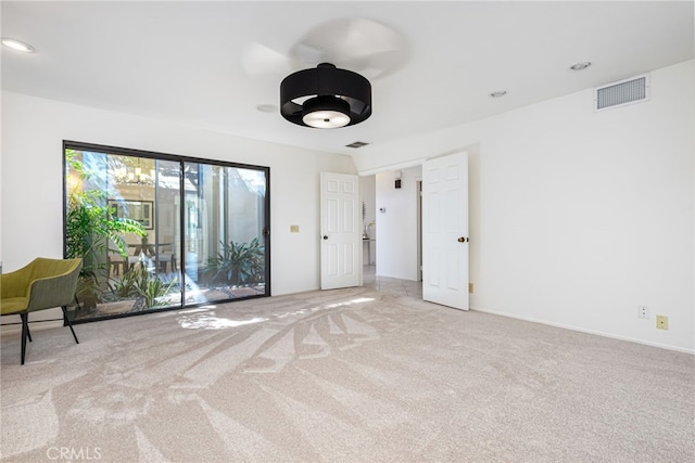 empty room featuring recessed lighting, visible vents, and carpet