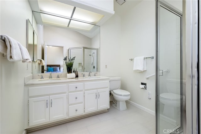 full bath featuring a sink, a shower stall, double vanity, and toilet