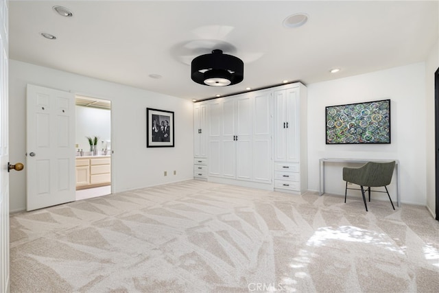 unfurnished bedroom featuring ensuite bathroom, a closet, baseboards, carpet flooring, and recessed lighting