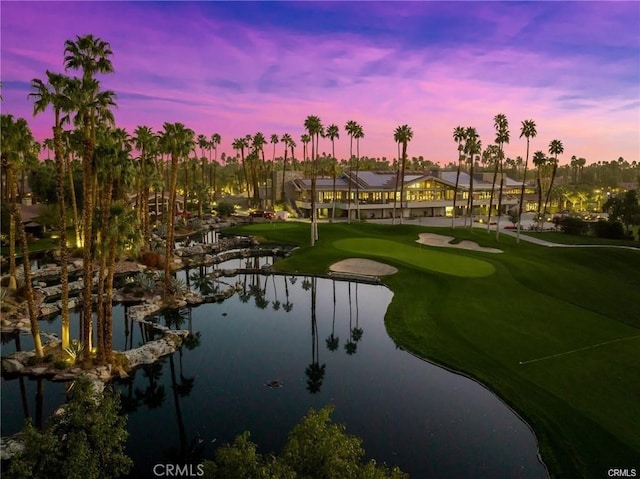 exterior space with view of golf course and a water view