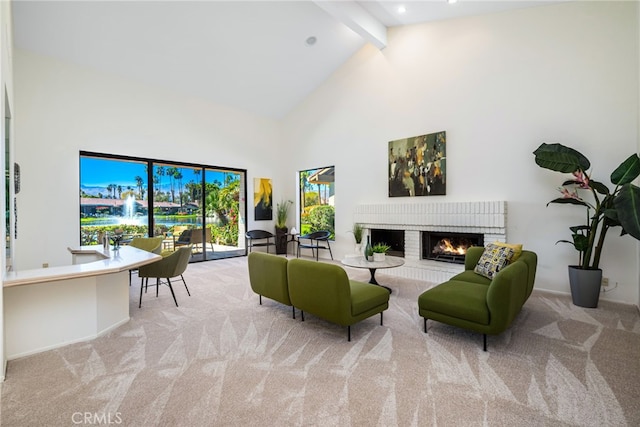 living area with carpet floors, beam ceiling, baseboards, a brick fireplace, and high vaulted ceiling