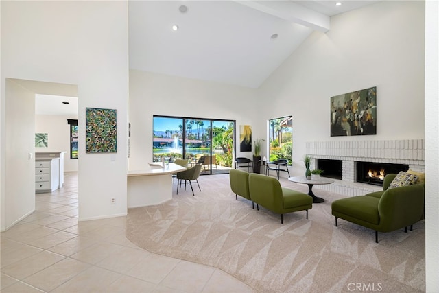 living area with high vaulted ceiling, a fireplace, beamed ceiling, and light tile patterned floors