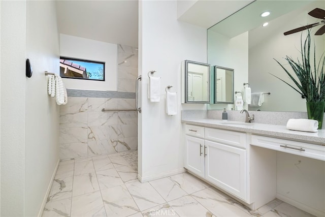 full bathroom with recessed lighting, marble finish floor, vanity, a marble finish shower, and baseboards