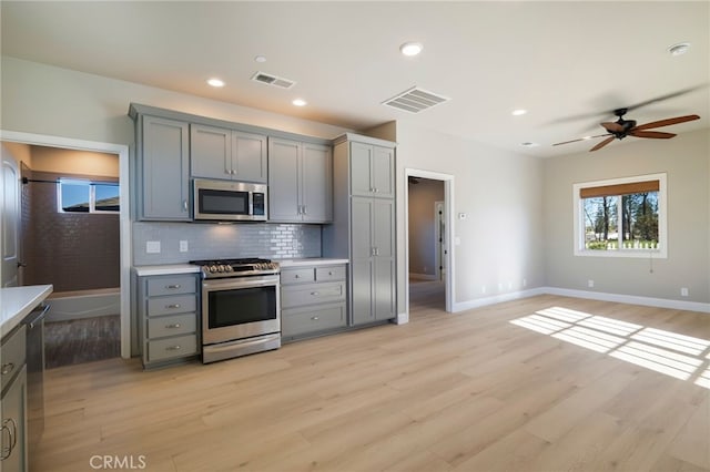 766 Willow St, Paradise, CA 95969 - kitchen with stainless steel appliances, decorative backsplash, gray cabinets, and visible vents