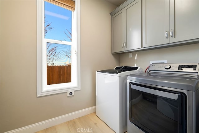 766 Willow St, Paradise, CA 95969 - laundry room with cabinet space, separate washer and dryer, baseboards, and light wood-style flooring