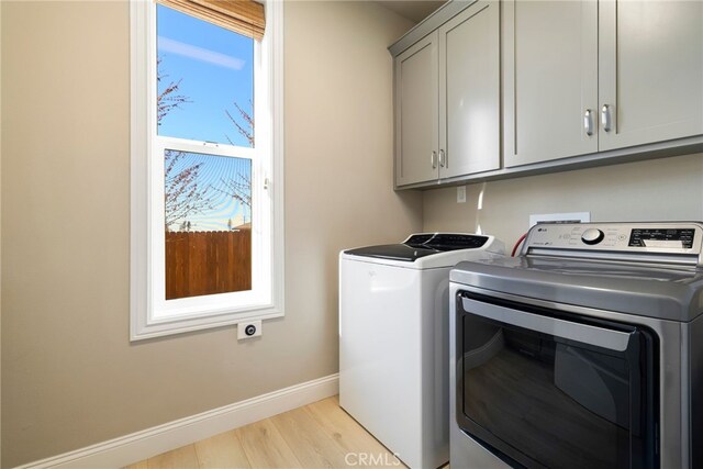 766 Willow St, Paradise, CA 95969 - laundry area with cabinet space, washing machine and dryer, and light wood-style flooring