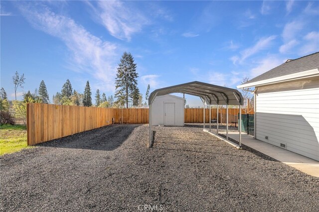 766 Willow St, Paradise, CA 95969 - view of yard featuring driveway, an outdoor structure, a fenced backyard, and a storage unit