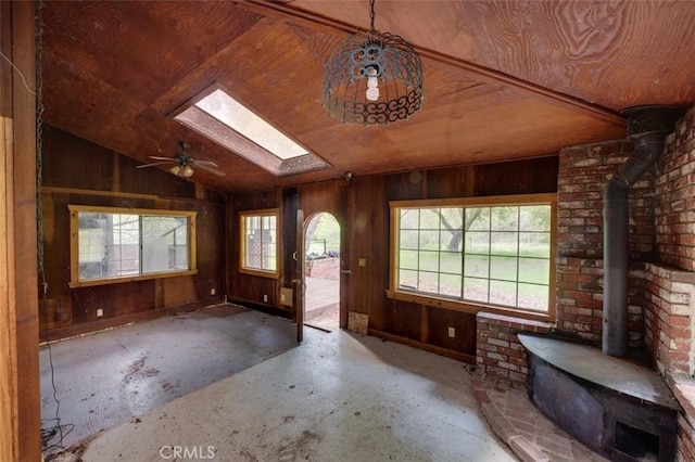 3399 Upper Lopez Canyon Rd, Arroyo Grande, CA 93420 - entryway featuring wooden walls, lofted ceiling with skylight, a wood stove, and plenty of natural light
