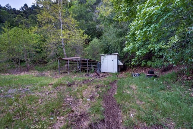 3399 Upper Lopez Canyon Rd, Arroyo Grande, CA 93420 - view of yard featuring a forest view, an outdoor structure, and a storage shed
