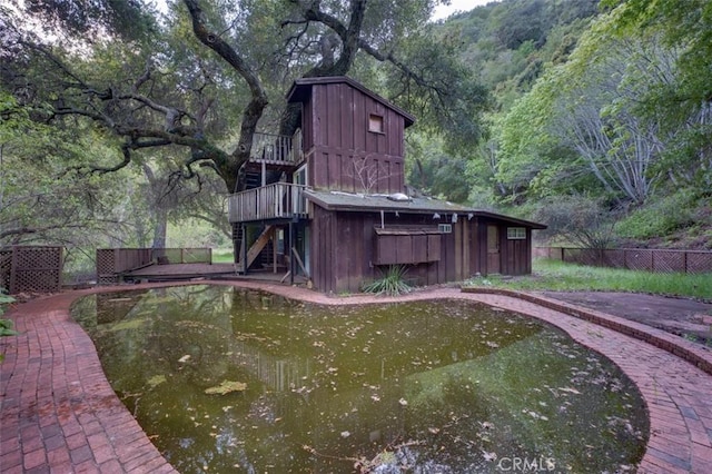 3399 Upper Lopez Canyon Rd, Arroyo Grande, CA 93420 - view of swimming pool featuring a wooden deck, a view of trees, stairs, and fence