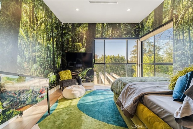 bedroom with wallpapered walls, multiple windows, and recessed lighting