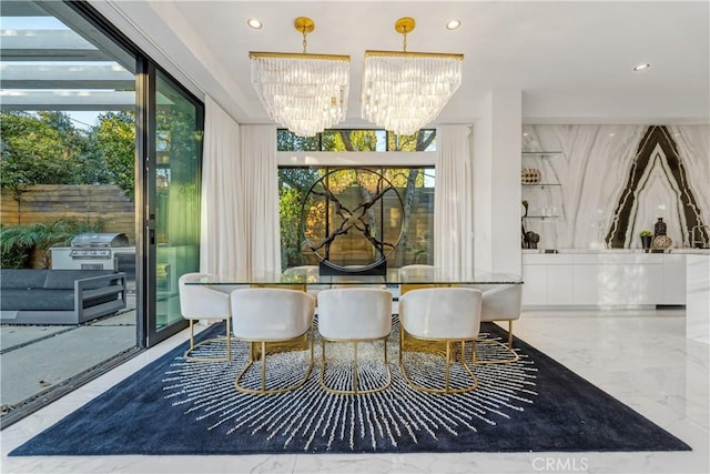 dining space featuring marble finish floor, a wealth of natural light, and an inviting chandelier