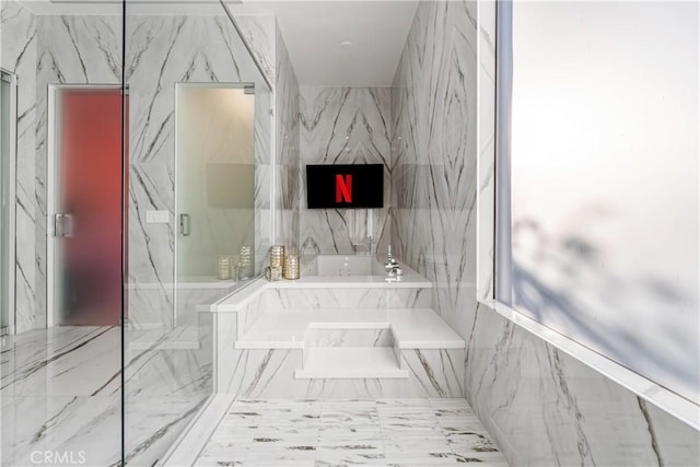 full bath with a marble finish shower and a garden tub