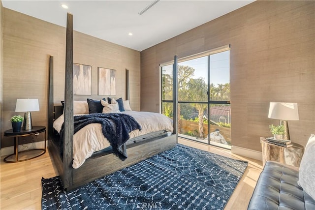 bedroom featuring baseboards, wood finished floors, and recessed lighting