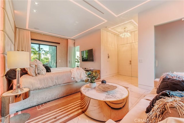 bedroom with marble finish floor and an inviting chandelier