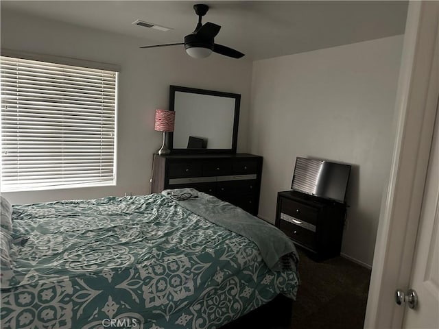 bedroom featuring visible vents, ceiling fan, and carpet floors