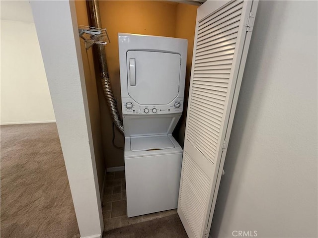 375 Central Ave Unit 12, Riverside, CA 92507 - laundry room featuring stacked washer / drying machine, carpet floors, and baseboards