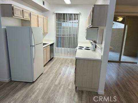 375 Central Ave Unit 12, Riverside, CA 92507 - kitchen with freestanding refrigerator and light wood-type flooring