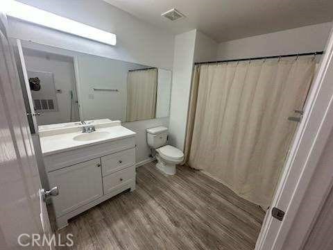 375 Central Ave Unit 12, Riverside, CA 92507 - bathroom featuring wood finished floors, vanity, and toilet