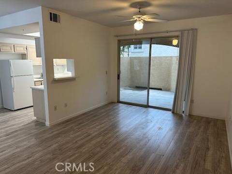 375 Central Ave Unit 12, Riverside, CA 92507 - unfurnished dining area with wood finished floors, a ceiling fan, and baseboards