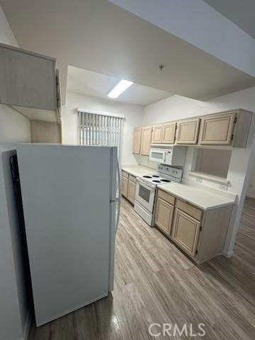 375 Central Ave Unit 12, Riverside, CA 92507 - kitchen with white appliances, wood finished floors, and light countertops