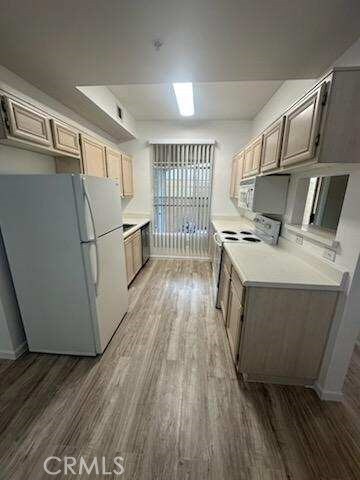 375 Central Ave Unit 12, Riverside, CA 92507 - kitchen with white appliances, wood finished floors, and light countertops