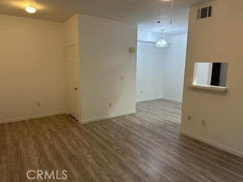 375 Central Ave Unit 12, Riverside, CA 92507 - unfurnished room with baseboards and wood finished floors