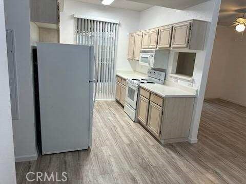 375 Central Ave Unit 12, Riverside, CA 92507 - kitchen featuring white appliances, a ceiling fan, light wood-style flooring, and light countertops