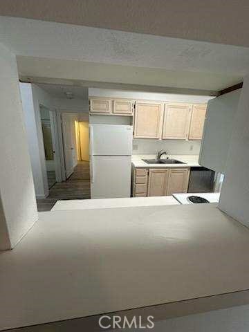 375 Central Ave Unit 12, Riverside, CA 92507 - kitchen featuring freestanding refrigerator, a sink, and light countertops