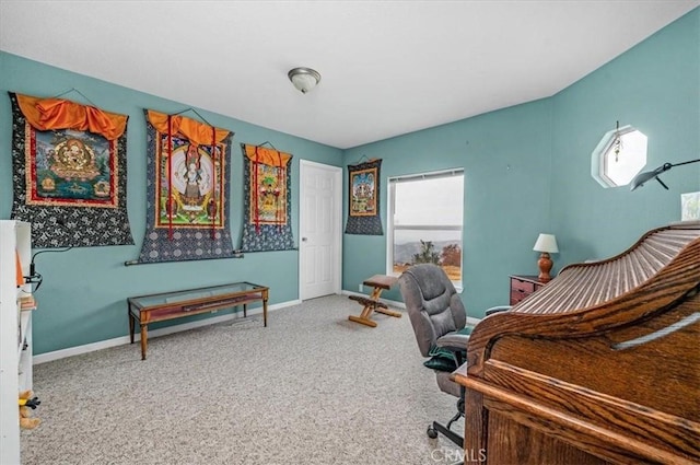 carpeted office featuring baseboards