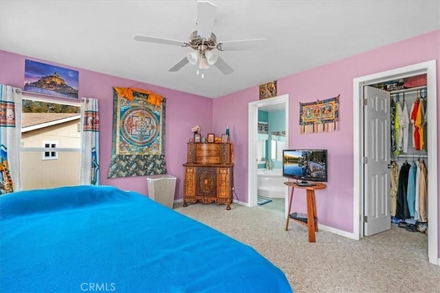 bedroom with a closet, carpet floors, ensuite bath, baseboards, and ceiling fan