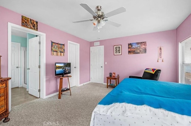 carpeted bedroom featuring baseboards, visible vents, and a ceiling fan