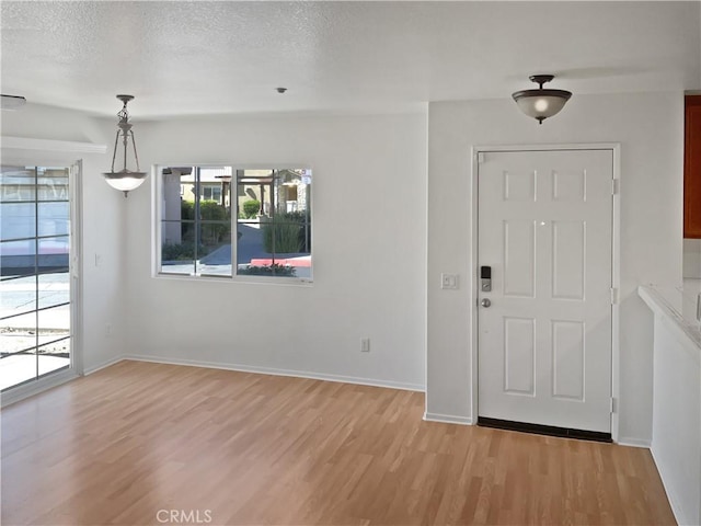 15605 Lasselle St Unit 6, Moreno Valley, CA 92551 - entrance foyer featuring light wood-type flooring, baseboards, and a textured ceiling