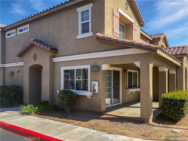 15605 Lasselle St Unit 6, Moreno Valley, CA 92551 - view of front of home with a patio area, a tiled roof, and stucco siding