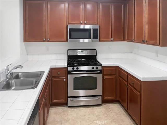 15605 Lasselle St Unit 6, Moreno Valley, CA 92551 - kitchen featuring stainless steel appliances, a sink, and tile countertops