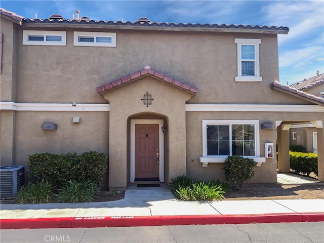 15605 Lasselle St Unit 6, Moreno Valley, CA 92551 - view of front facade featuring stucco siding, cooling unit, and a tiled roof