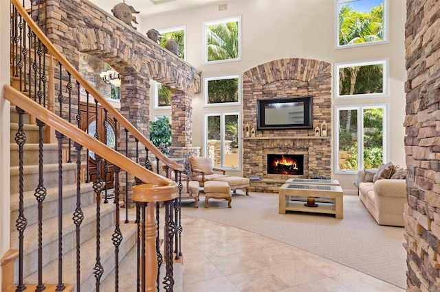 5023 Windsor Dr, San Diego, CA 92109 - living room featuring a high ceiling, plenty of natural light, a fireplace, and stairway