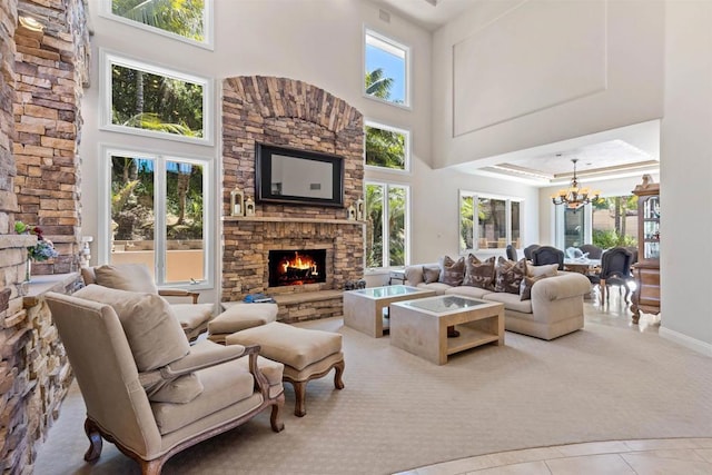5023 Windsor Dr, San Diego, CA 92109 - living room with a towering ceiling, a stone fireplace, a chandelier, and plenty of natural light