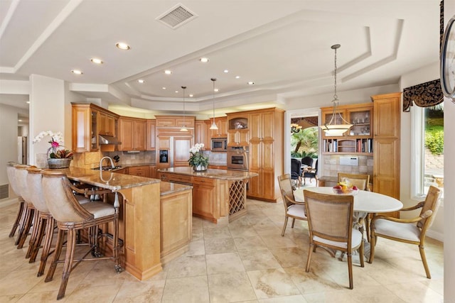 5023 Windsor Dr, San Diego, CA 92109 - kitchen with a raised ceiling, stainless steel appliances, tasteful backsplash, a peninsula, and recessed lighting